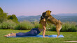 Young woman is doing yoga stretches when a playful dog comes and licks her face