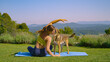 Young lady and her cute mixed breed dog sit on yoga mat in the middle of garden