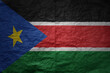 big national flag of south sudan on a grunge old paper texture background