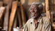 Joyful Elderly African Man Laughing Candidly in a Workshop