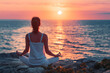 © VisualProduction - Young woman practice yoga and meditation near the sea at sunrise, healthy lifestyle concept, lotus position