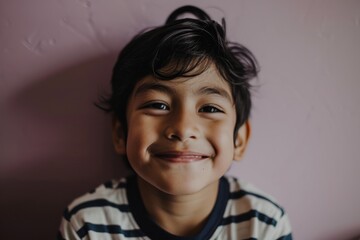 Portrait of a cute little boy smiling and looking at the camera