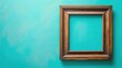 Wooden picture frame on teal blue background