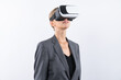 © InfiniteFlow - Manager wearing visual reality glasses and looking around and explore at metaverse and visual world. Caucasian business woman standing and using VR glasses and technology innovation. Contraption.