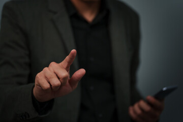 businessman is holding smartphone and pointing index finger