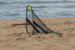 Small beach soccer goal near ocean. .