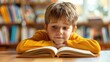 Young child reading book with focus and interest