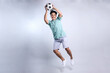 Full Length of  Attractive Young Asian Man Throwing or Catching Soccer Ball Isolated on White Background