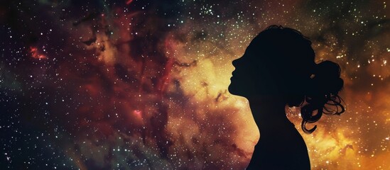 Wall Mural - A female is standing outside, looking up at the beautiful stars twinkling in the night sky with awe and wonder