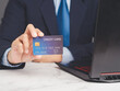 Hand holding a blue credit card. Online payment concept.