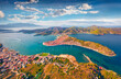 Spectacular summer cityscape of Galatas town with public stadium. Splendid morning view of Poros port. Aerial morning seascape of Myrtoan Sea. Traveling concept background.
