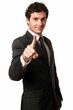 Young male professional in suit gesturing towards camera with focus and determination.
