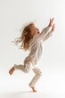 A young girl with hair flowing mid-air showcasing pure joy and freedom.