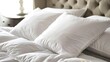 Plush white pillows up close, setting the stage for a night of sweet dreams and restful sleep