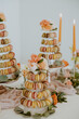 Closeup of Macaroon Tower with Candles in Background
