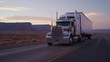 A stunning image unfolds as a massive semi-truck confidently maneuvers through the southwest U.S. on an isolated road. The HD camera perfectly captures the essence of the American highway.