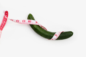 Wall Mural - Measuring tape around cucumber on white background.