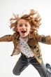 Young girl caught mid-air with flowing hair and a bright smile, radiating happiness and energy.
