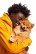 An ecstatic young man in a vibrant orange hoodie hugging a happy Pomeranian, both sharing a moment of pure joy.