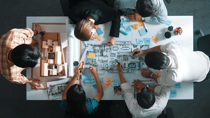 Wall Mural - Top aerial view of project manager or civil engineer writing at blueprint and planning building design. Aerial view of architect working together at meeting table with document placed. Alimentation.