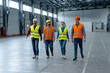 © Maria Vitkovska - Group of smiling successful managers, engineers, workers wearing hard hats, work wear, vests