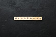 menopause word written on wood block. menopause text on table, concept