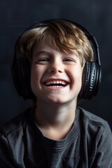 Wall Mural - Happy young boy listening to music, suitable for technology and lifestyle concepts