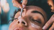 A beautician removes unwanted hair from a woman's face with hot wax. This procedure helps maintain skin health and enhances beauty.