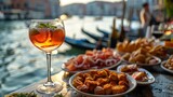 Fototapeta Uliczki - Enjoy a refreshing Aperol spritz paired with assorted appetizers against the backdrop of a serene Venetian canal. Perfect setting for a delightful evening.