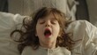 © Fotograf - A young girl laying in bed with her mouth open. Suitable for medical or sleep-related concepts