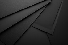 A Stack Of Black Sheets Of Paper Ready For Use In Various Projects