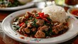 Spicy pork served on a white plate Lao cuisine
