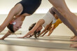 Close-up of yoga students in a studio.