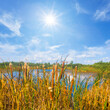 small blue lake among prairie under a sparkle sun