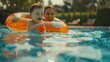 A woman and a child enjoying playtime in a swimming pool. Suitable for family and leisure concepts