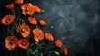 A sparse display of orange poppies stretching diagonally across the upper left corner of a matte black background, highlighting their vivid color with abundant negative space.