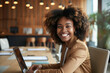 © AI_images - A joyful businesswoman smiles brightly in the boardroom of an office, accompanied by her laptop.