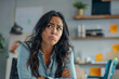 © AI_images - A worried Latina businesswoman confronts work difficulties in the office, her expression reflecting stress and pressure.