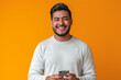 © AI_images - An enthusiastic Latina man, in his late 20s, smiles warmly as he recommends a smartphone app on a vibrant orange background, showcasing his engaging personality and persuasive abilities.