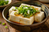 Fototapeta Kosmos - Generative AI Image of White Tofu with Salty Soy Sauce and Sliced Spring Onions in Bowl