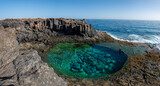 Fototapeta Desenie - Cliffs aerials view of natural pools in Caleta de Fuste, a beautiful oasis with emerald clear waters in Fuerteventura island