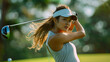 Confident female golfer in action on a sunny day at the golf course.