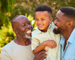 © Monkey Business - Loving Three Generation Male Family Laughing And Hugging Outdoors In Countryside