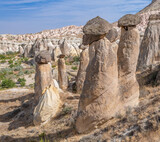 Fototapeta Zachód słońca - Fairy chimneys, unique rock formations near Cavusin Town in Cappadocia, Turkey..