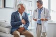© MD Media - A doctor is examining an elderly man with stomach pain in the medical room, holding his belly. Portrait of senior man sharing health issues struggles with his medical professional carer practitioner