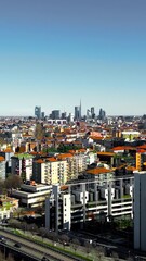 Wall Mural - Milan city skyline aerial view flying towards financial area skyscrapers