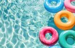 Three Inflatable Swimming Rings Floating in a Pool