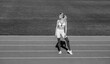 © Yevhen - Woman on stadium track. Sportswoman wearing sportswear. Black and white