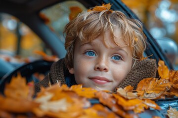 An adorable boy peeking over a car window surrounded by golden autumn leaves