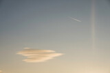 Fototapeta Przestrzenne - single soft colorful cloud with a aeroplane on the sky during sundown